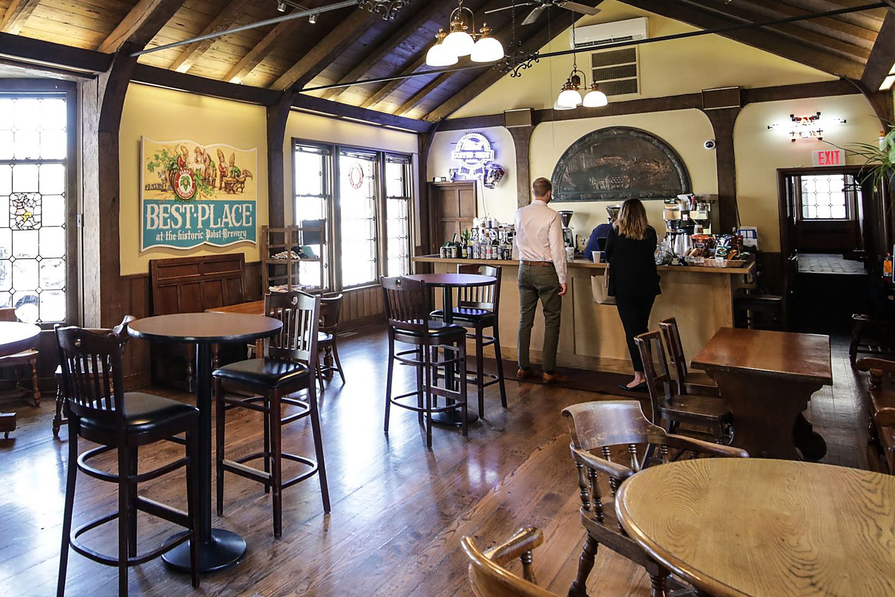Best Place Coffee and Spirits, with tall windows, wood beams, and coffee seating